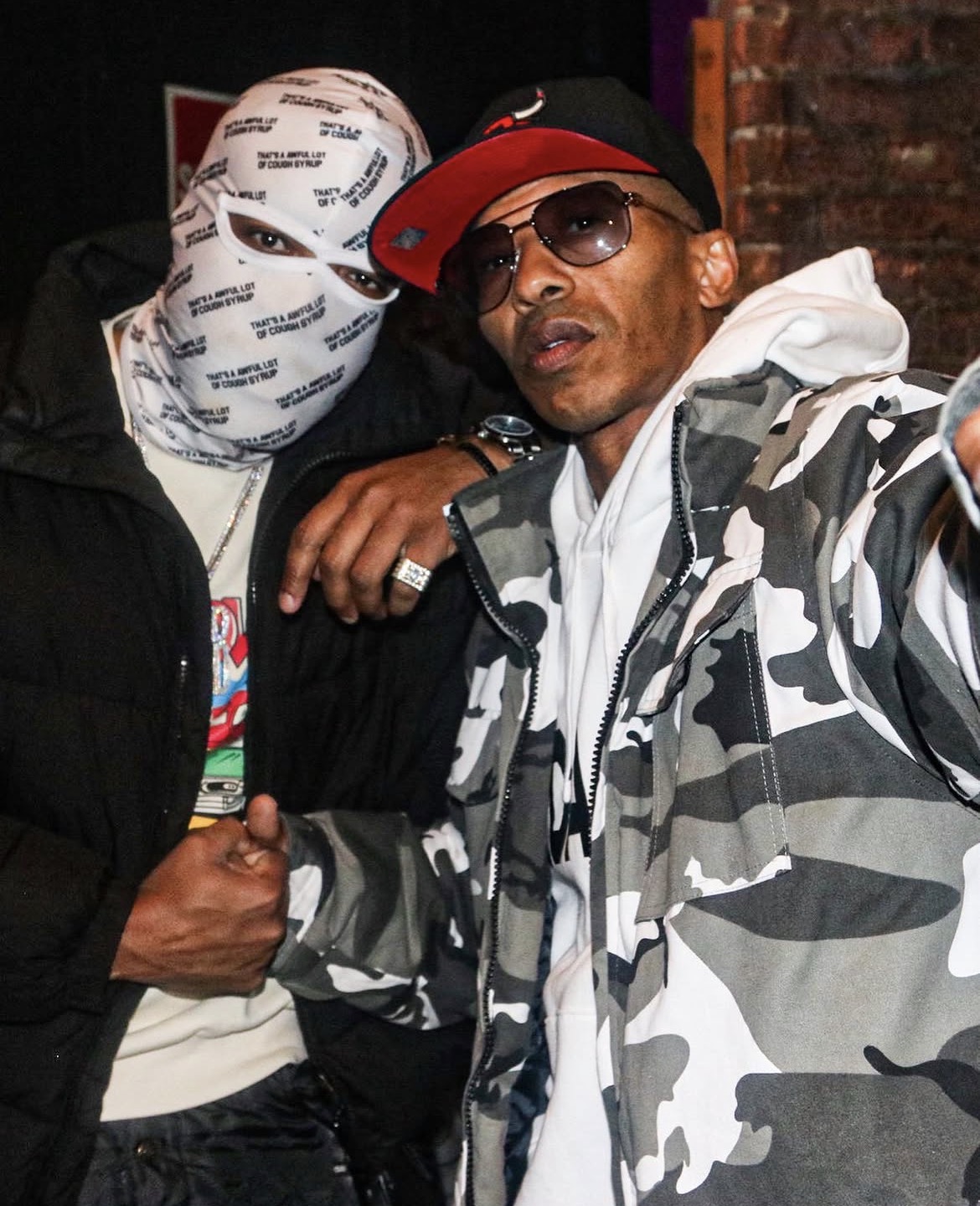 Two guests photographed with flash at a night venue