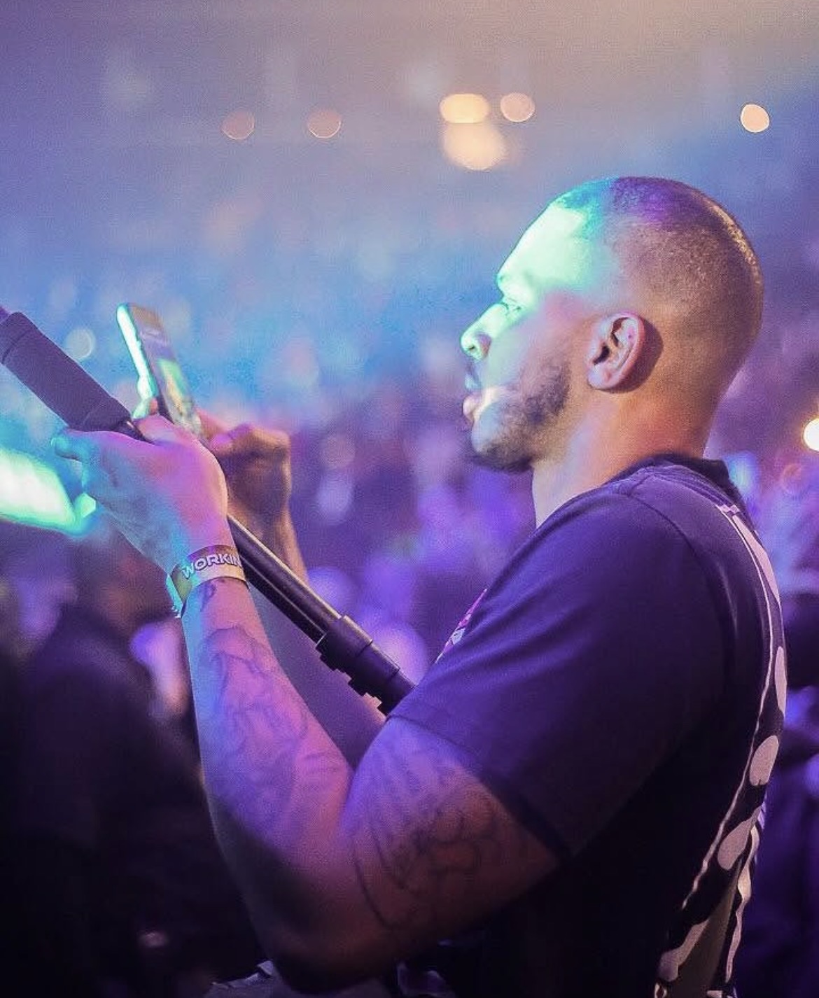 Vante shooting from inside the crowd under stage light