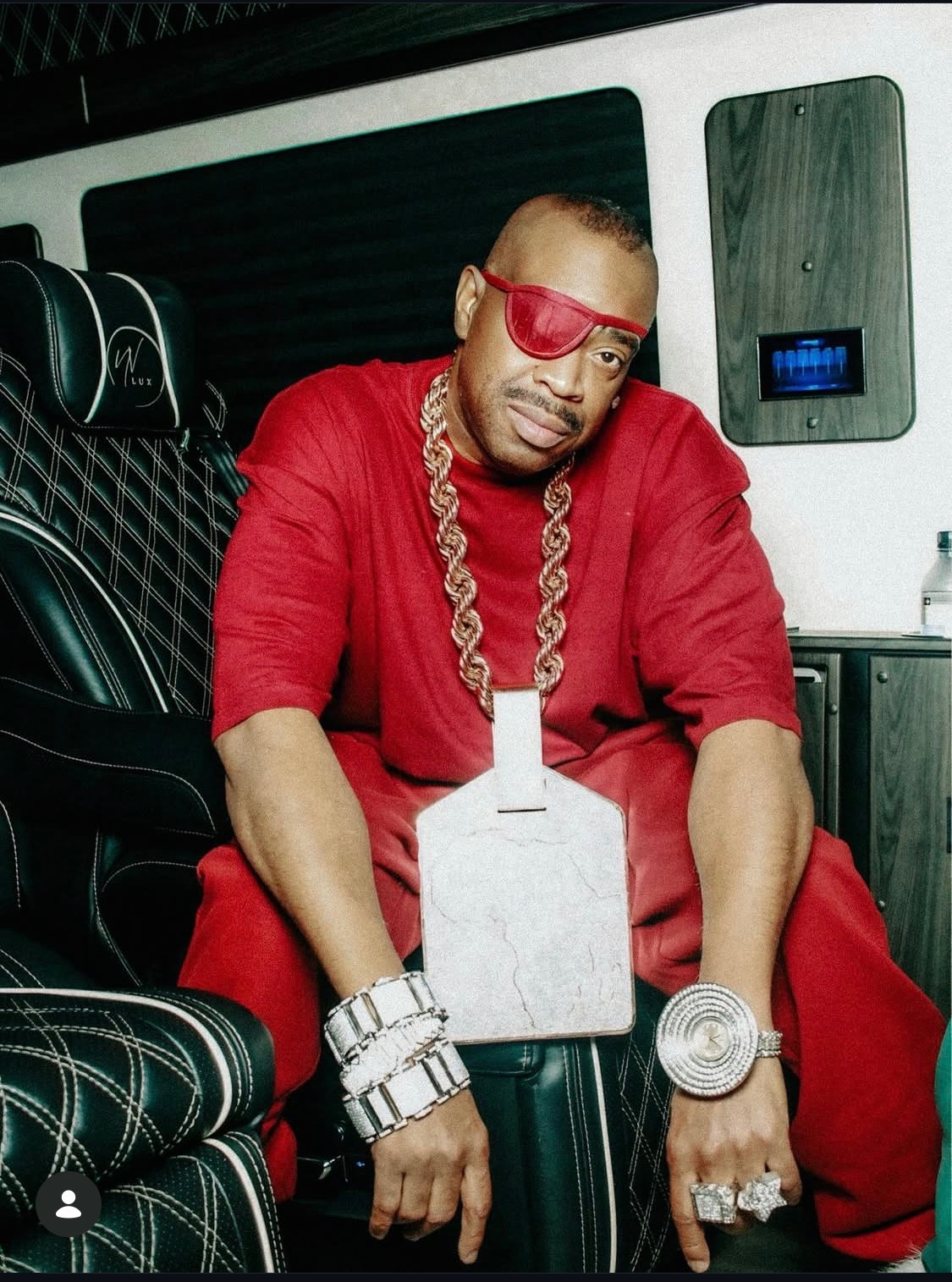 Seated guest dressed in red with jewelry in an entertainment setting