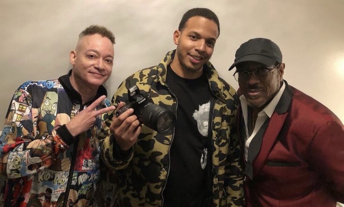Three men photographed at an entertainment event