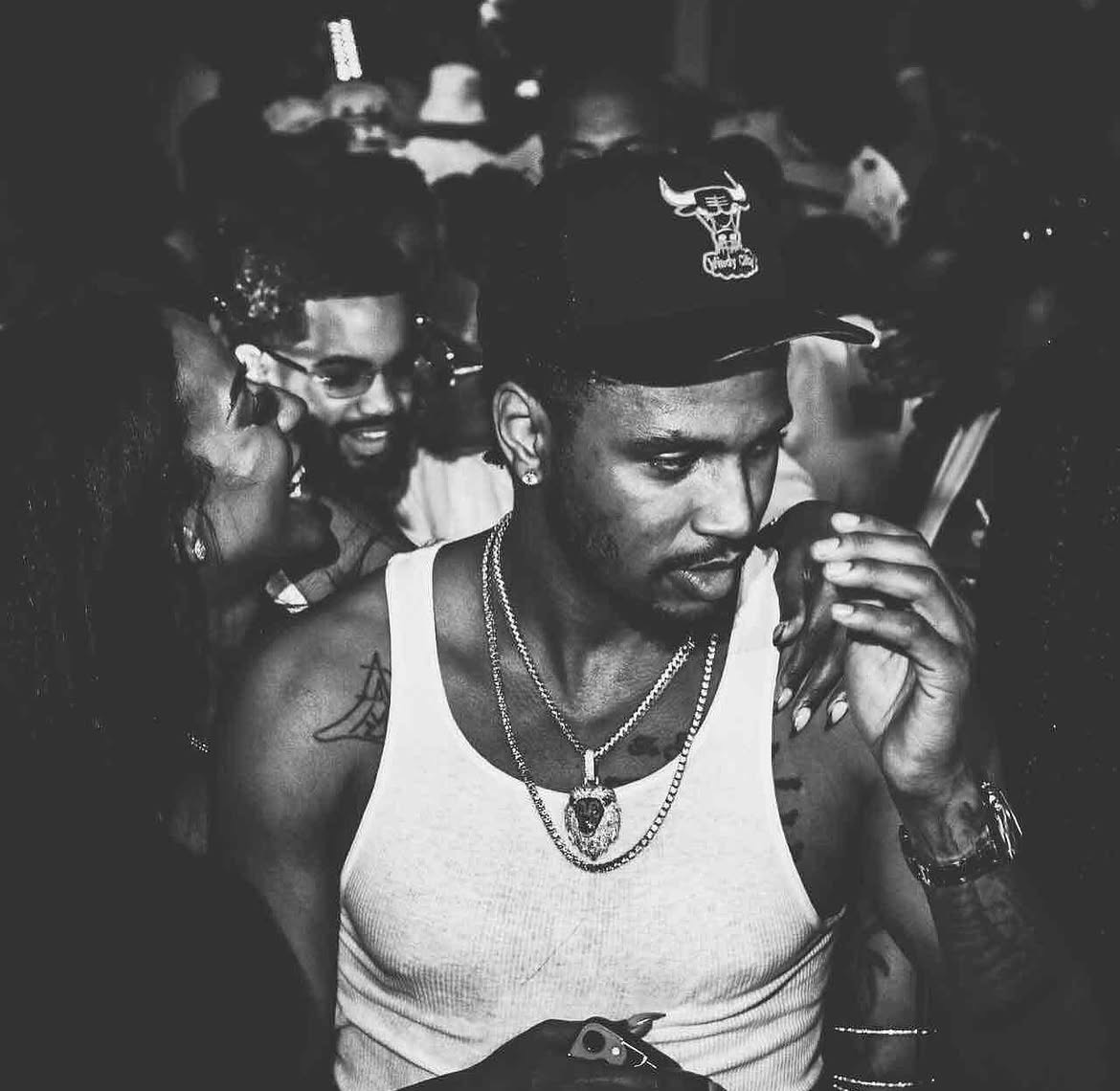 Black and white portrait of a guest inside a packed room
