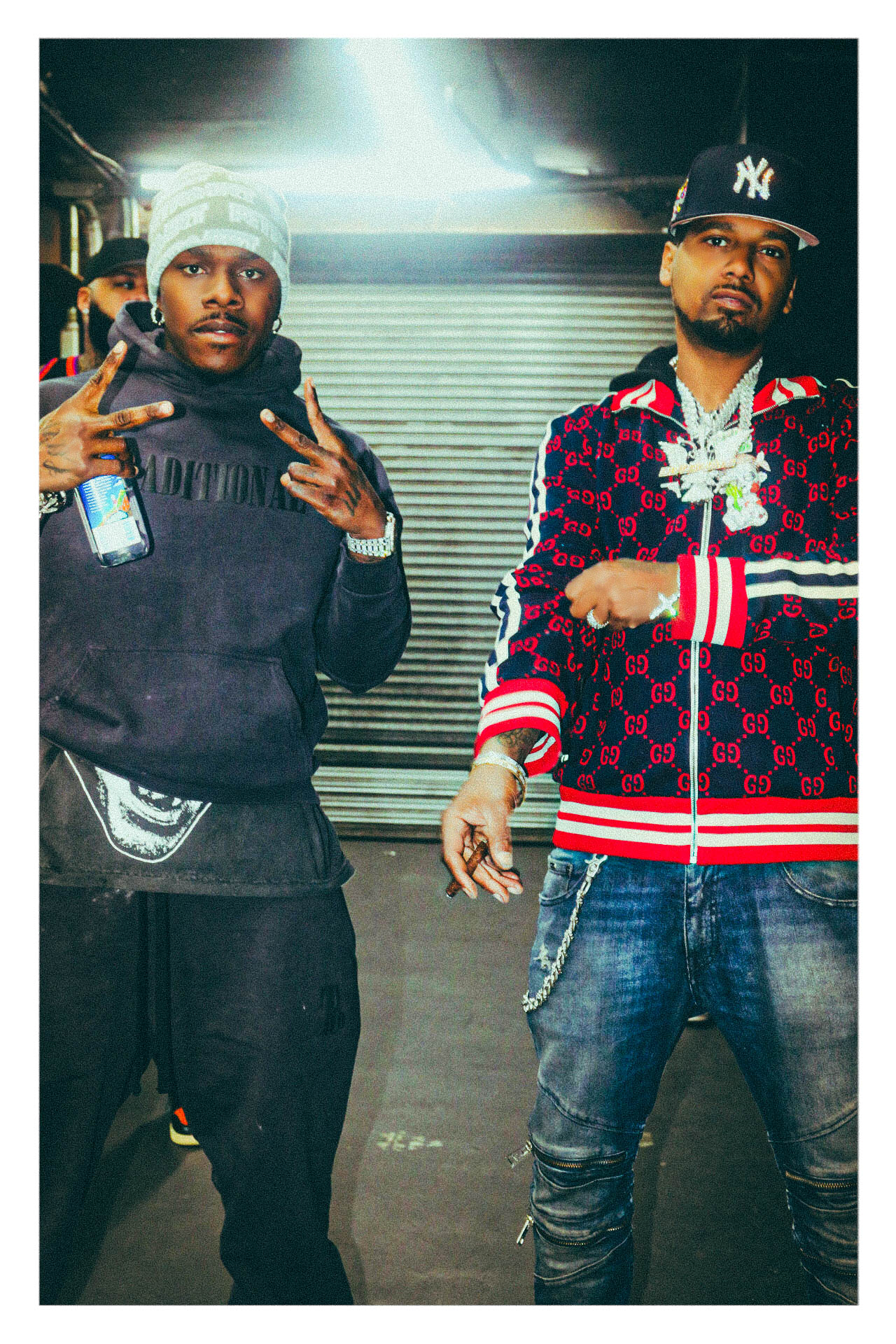 Two artists photographed backstage in a service corridor