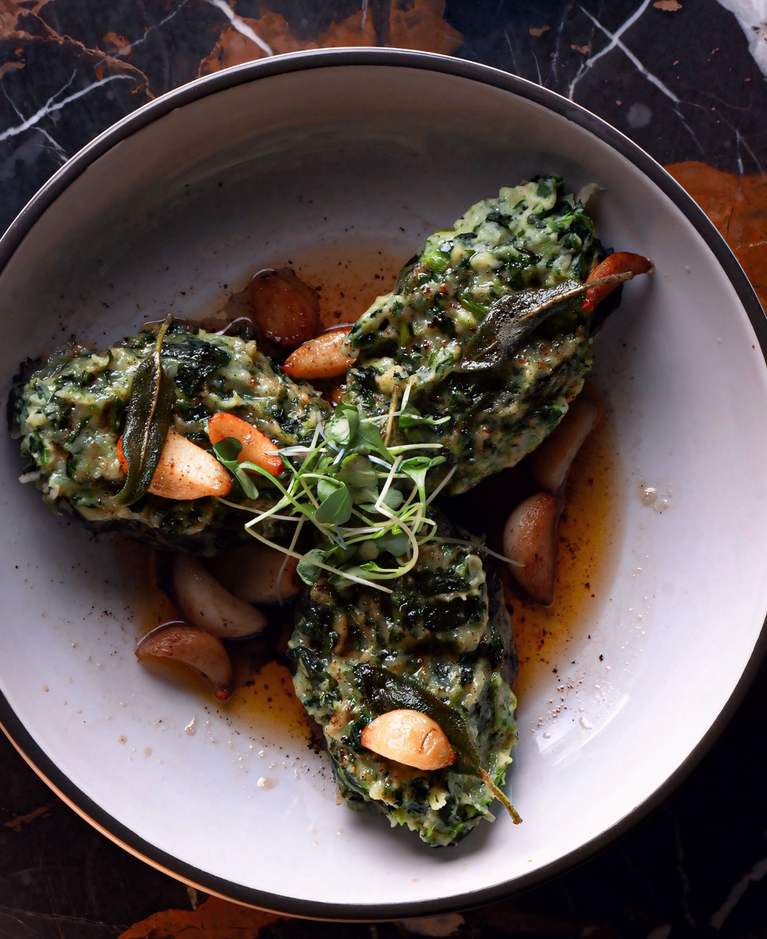 Green vegetable course plated with garlic